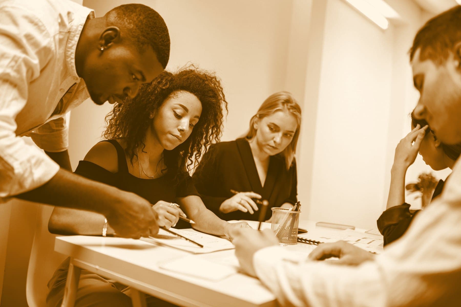 Colleagues around a table, making notes on printed pages